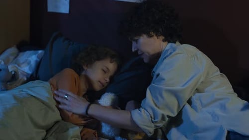 Loving Mother Comforts Child at Bedtime