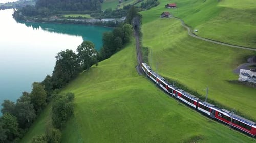Lush Swiss landscape with commuter train and lake, Lungern, Obwalden, Switzerland