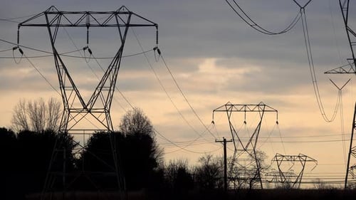 Electrical Towers Silhouetted Against Sunrise or Sunset