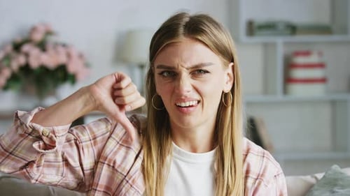 Young Woman Thumbs Down Expressing Dislike