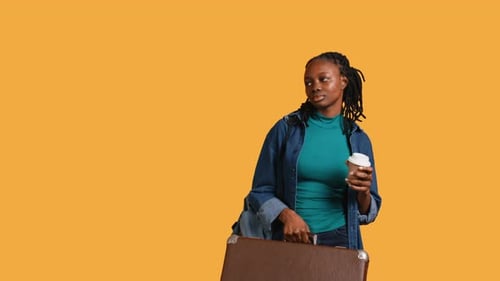 Tired Girl Travelling with Suitcase Drinking Coffee Studio Background
