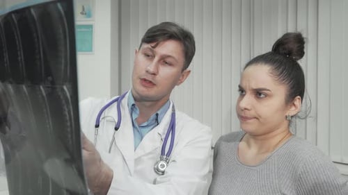 Doctor Explains X-Ray Results to Patient
