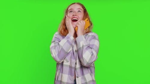 Woman Celebrates Good News on Mobile Phone