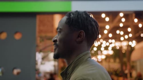 Side View Of Adult Walking In Cafe With Warm Smile