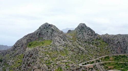 Beauty in Nature: Majestic Mountain Landscape with Dramatic Clouds and Vast Sky, aerial drone