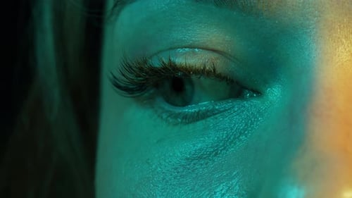 Closeup Womans Blinking Eye with Long Eyelash and Contact Lens Beauty Make Up of Green Eye with Neon