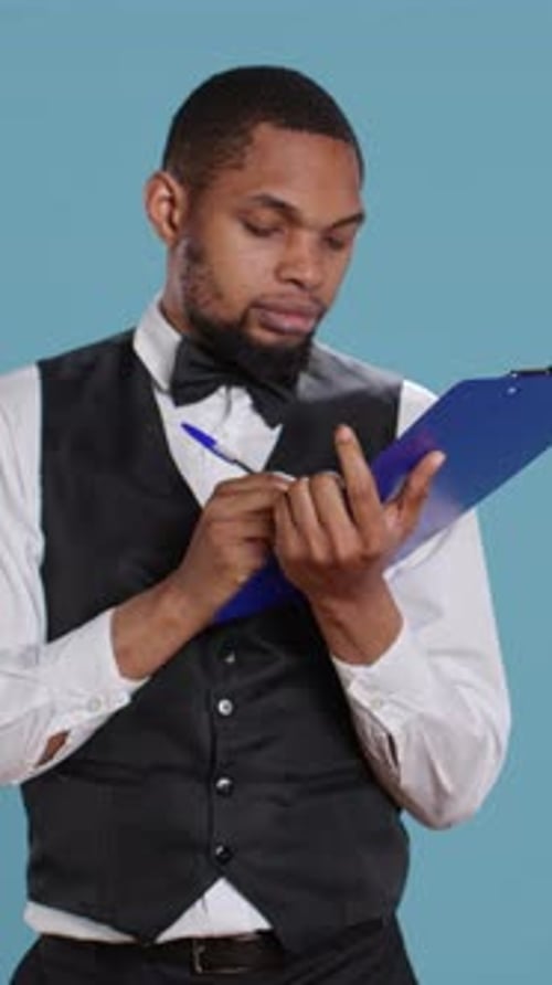 Vertical Video Receptionist Worker Writing Down Notes on Clipboard Files