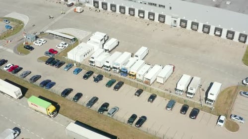 Aerial View of a Modern Logistics Center with Various Semitrailer Trucks