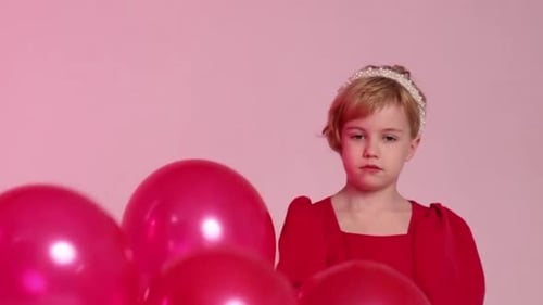 Girl Smiling with Red Balloons