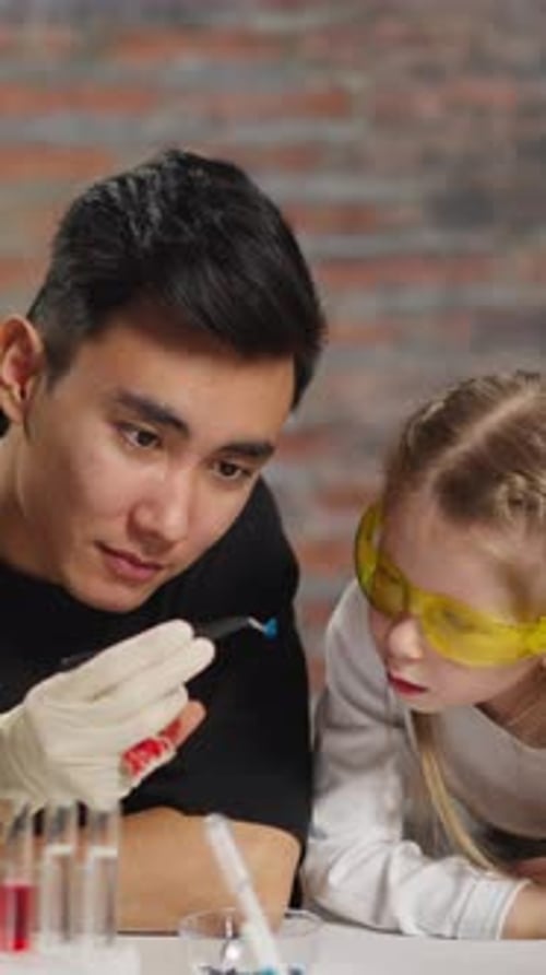 Science Experiment with Adult and Child Indoors