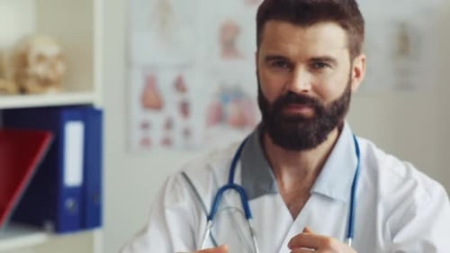 One Goodlooking Doctor with Brown Hair Looking at Camera at Clinic Kind Positive Caucasian Physician
