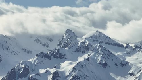 Snowy Mountains and Cloudy Skies in Winter