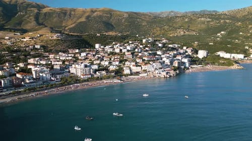 Cinematic Establishing Shot Above Albanian Riviera Beach Town on Typical Summer Day