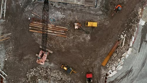 Aerial Top Down View of Construction Site with Excavators and Dump Trucks During Earthworks and