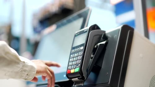 Close up man At Counter Buy electronic payment supermarket by credit card close-up. Male hand pay