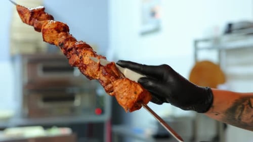 Close Up of Chef Preparing Meat Skewer