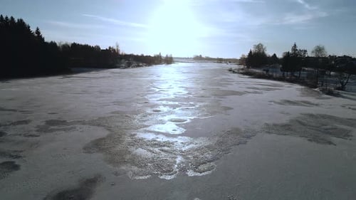Flight over frozen river in winter