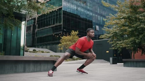 Athletic Man Stretching Leg Muscles Outdoors