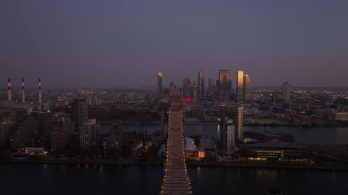 Aerial View of Queensboro Bridge Showcases the Illuminated Skyscrapers of Long Island City Queens