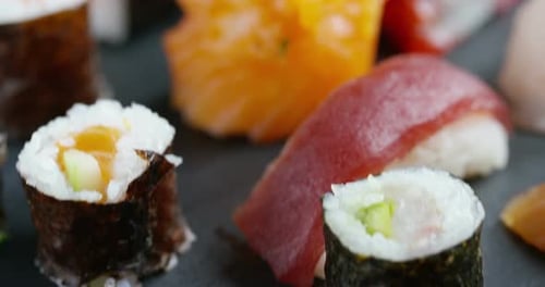 Macro shot of sushi, sashimi, uramaki and nighiri. typical Japanese dish consisting of rice, salmo