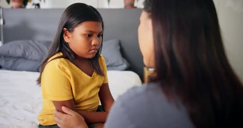 Young Girl Talking to Adult on Bed