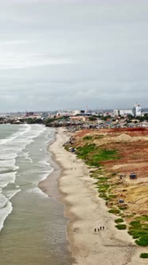 Aerial view of Accra coastline showcasing urban landscape and waves