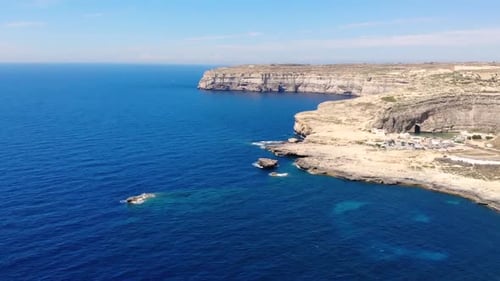 Gozo sea cliffs aerial drone pan shot in mediterranean sea, Gozo island in Malta.