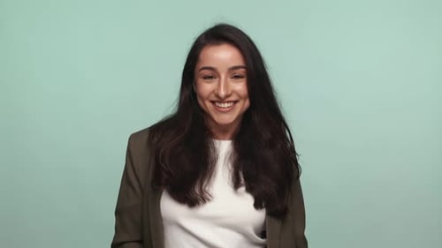 Confident Woman in Blazer Dancing Joyfully in Studio