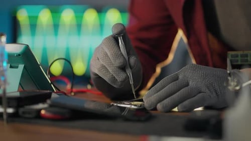 Chip. Workshop worker uses professional skills holding a screwdriver in his hands in a repair shop