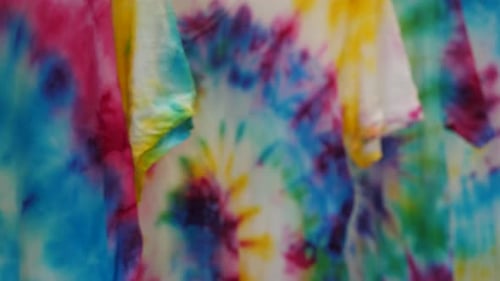 Colorful Tie-Dye Shirts Hanging on a Rack