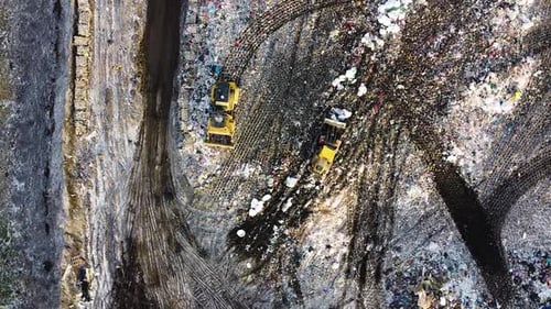 Aerial flyover landfill full of trash, pollution environmental problem, garbage, trucks dump waste p