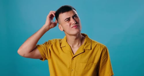 Thinking, confused and man in studio with idea, hand on head for memory or problem solving decision