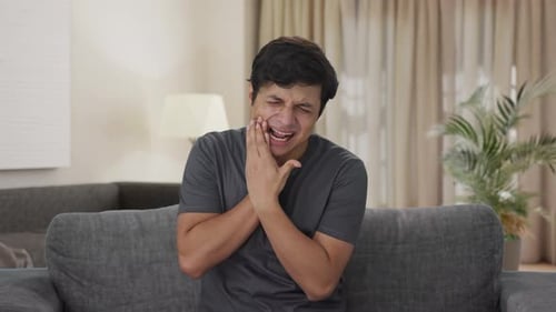 Sick Indian man suffering from tooth pain