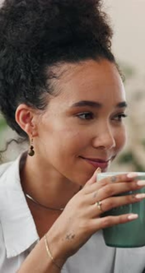 Attractive Woman Sipping Refreshing Beverage at Home