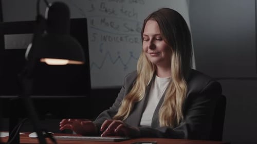Woman Works at Computer in Office