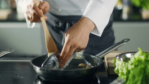 Famous Restaurant Chef Turns Over Fish on a Hot Pan. Close-up Shot of Pan.