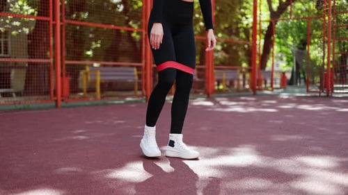 Woman Working Out with Exercise Band Outside