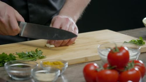 Cook Crushed the Garlic with a Knife and Cut It Into Small Pieces