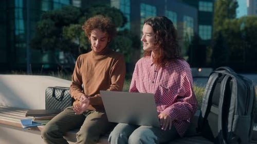 Smiling Students Talking and Laughing Outdoors on Campus at Modern University