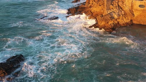 Aerial View of Rocky Cliff Coastline with Ocean Waves