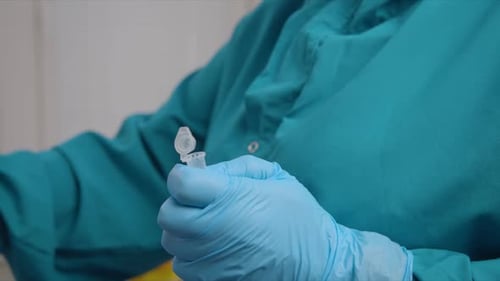 Doctor Puts Coronavirus Smear Sample Into Container Closeup