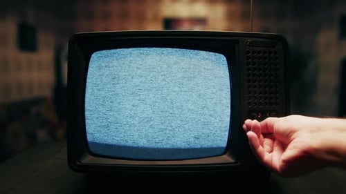Vintage Television with Static Being Tuned By Hand