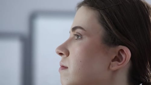 Artist doing beautiful makeup on woman's face indoors, closeup