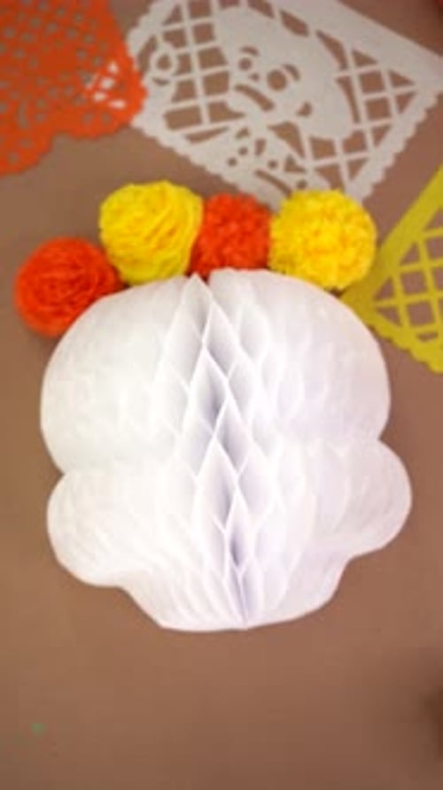 Paper honeycomb skull decoration with flowers for Day of the Dead celebration