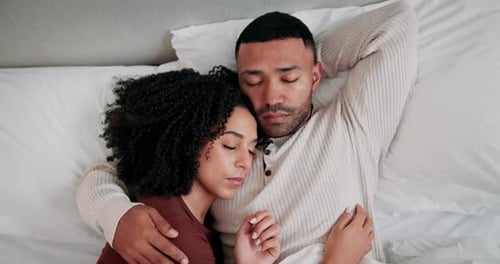 Loving Couple Embracing Peacefully in Bed Together