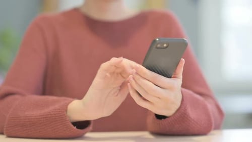 Close up of Beautiful Woman Browsing Internet on Smartphone