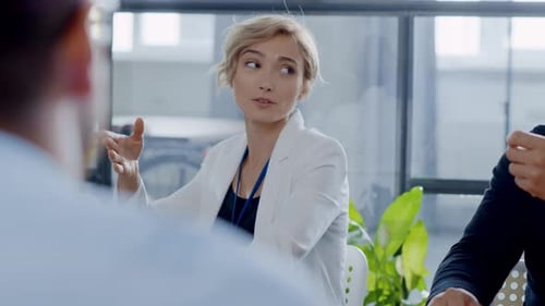 Young Woman Explains Business Strategy in Modern Office