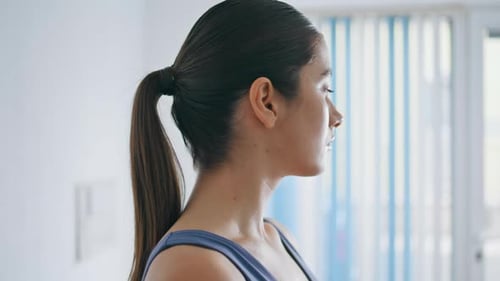 Attractive woman looks over shoulder indoors in daytime