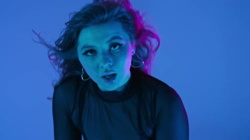 Stylish Woman Posing with Neon Lighting Effects