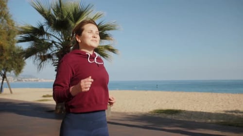 Happy Young Woman Running on Beach Exercising Cardio Workout Training